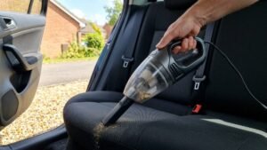 Car vacuum being used on the back seat of a car
