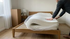 Mattress in a box being unrolled onto a timber bed frame