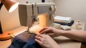 Fabric being guided through a sewing machine on a craft table