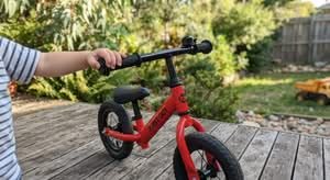 Close-up of a red balance bike, highlighting it as one of the best balance bikes for toddlers in Australia.
