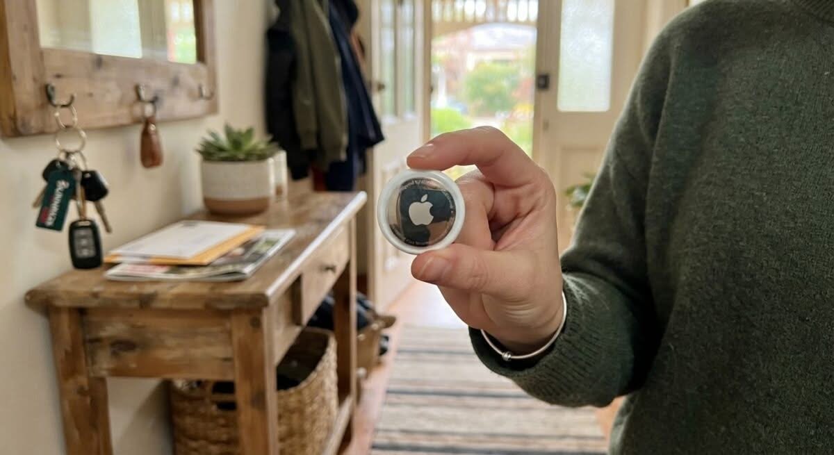 Close-up of someone holding the best Bluetooth tracker in Australia, ready to attach it to keys.