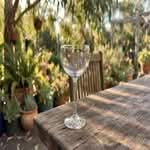 A single, high-quality cocktail glass, highlighting it as one of the best cocktail glasses in Australia, on a rustic table.
