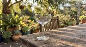 A single, high-quality cocktail glass, highlighting it as one of the best cocktail glasses in Australia, on a rustic table.