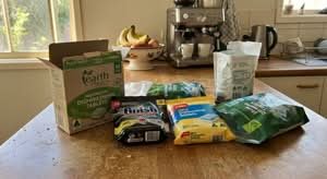 A variety of best dishwashing tablets available in Australia, shown in a natural home kitchen setting.