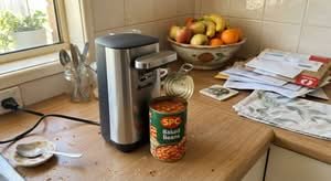 Close-up candid shot of one of the best electric can openers Australia has to offer on a kitchen counter.