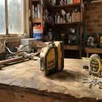 A DeWalt laser level on a workbench, representing the best laser levels in Australia.
