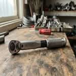 A close-up smartphone photo of the best torque wrenches Australia has to offer, resting on a workbench.