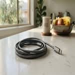 Close-up smartphone photo of the best USB-C cable Australia, coiled on a kitchen counter with natural light.