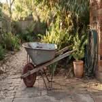 A single best wheelbarrow for sale in Australia, shown outdoors in a typical backyard setting.