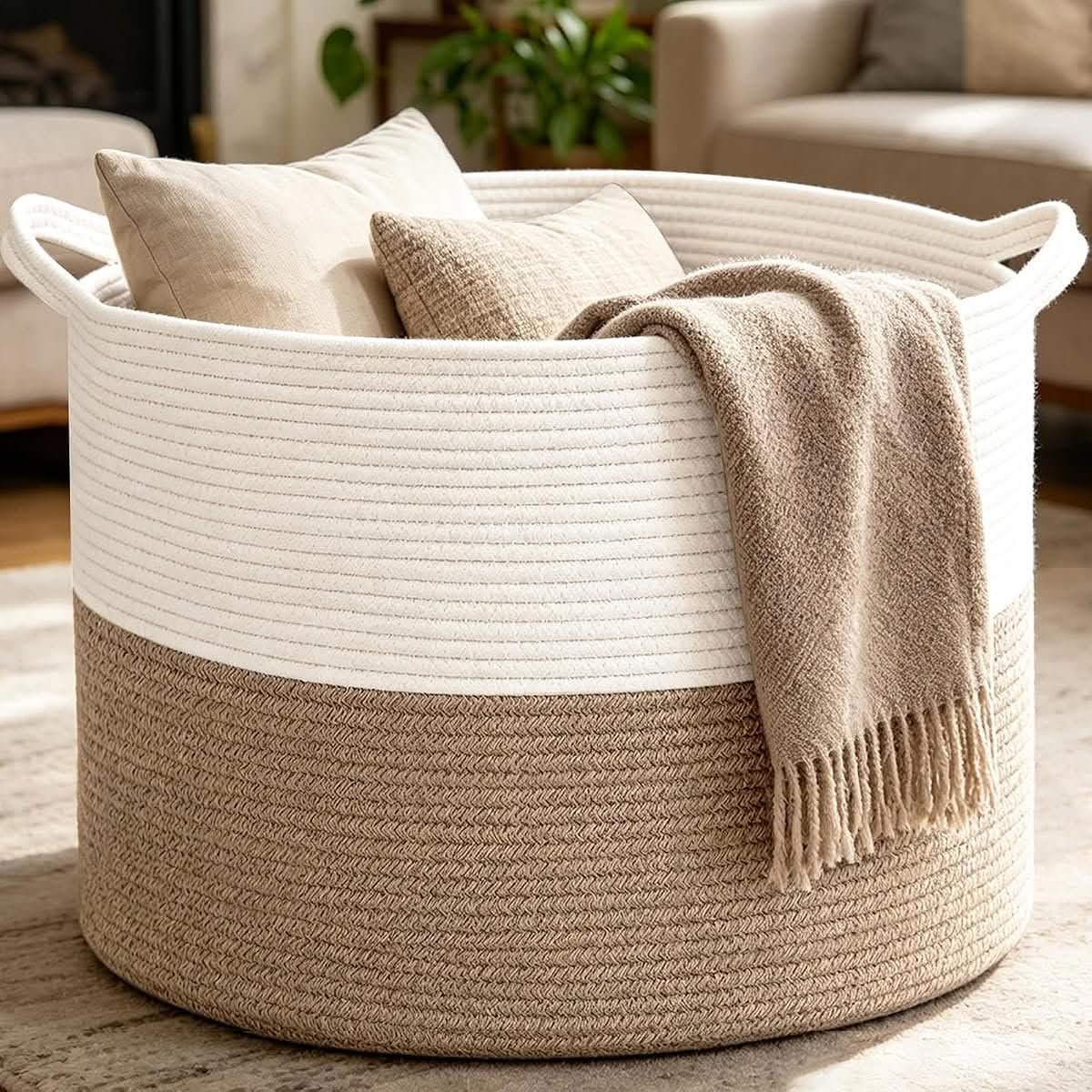 White and brown 65 litre woven blanket basket with handles in a living room