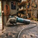 An unbranded angle grinder on a wooden workbench representing the best angle grinders australia for DIY projects.