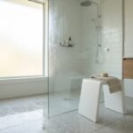 A modern bath stool inside a bright Australian home bathroom with natural light