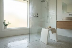 A modern bath stool inside a bright Australian home bathroom with natural light