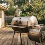 A stainless steel BBQ smoker set up on a backyard deck in Australia representing the best bbq smokers australia.