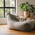 A comfortable neutral grey bean bag in a sunlit Australian living room, showcasing the best bean bags in Australia.