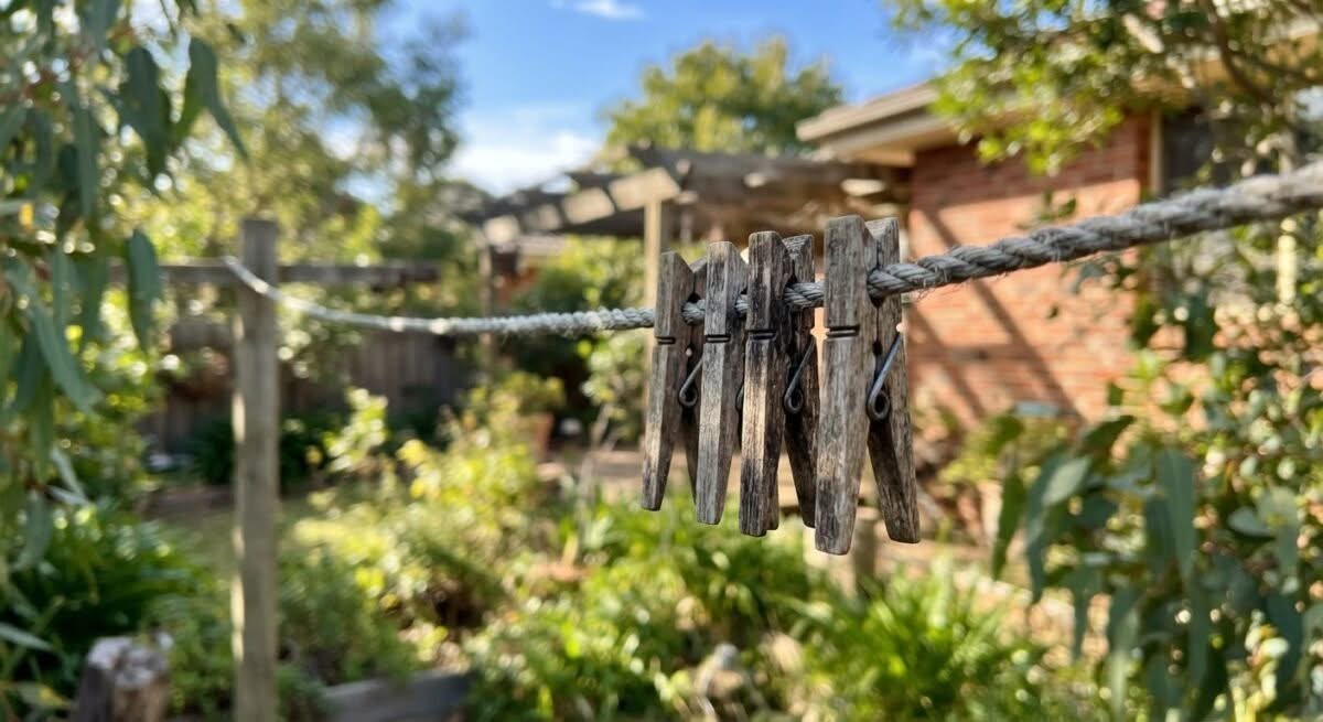Wooden clothes pegs drying laundry on a clothesline in Australia, highlighting the best clothes pegs australia.